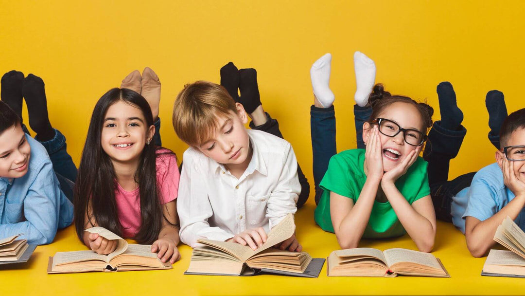 Children on their fronts reading books against a bright yellow background