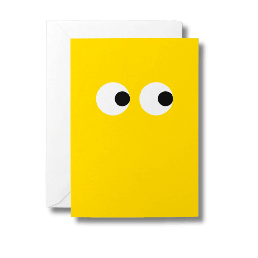 Bright yellow greeting card with large, black and white eyes