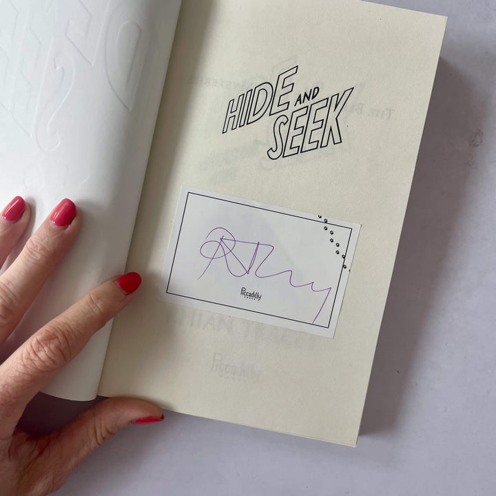 Open copy of Hide and Seek showing the bookplate signed by the author