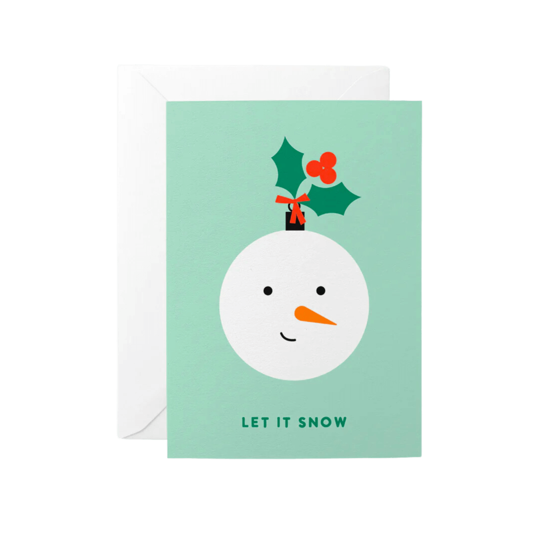 Pale green Christmas card reading Let it Snow. Image of a bauble in the shape of a snowman face.