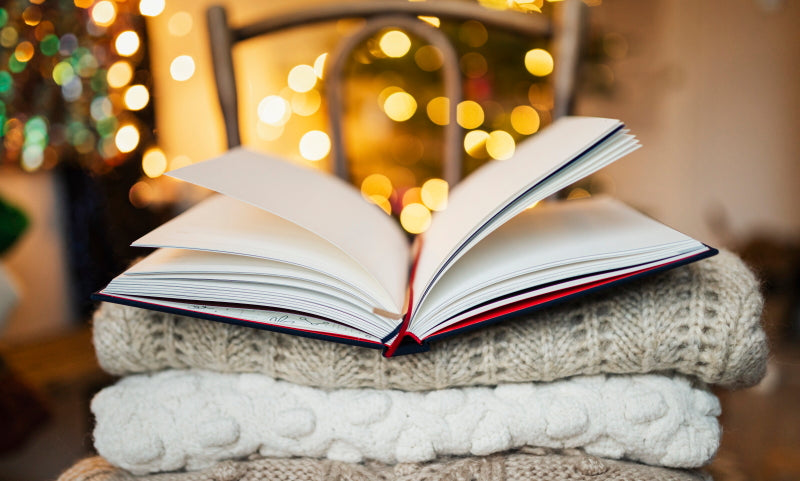 Book in front of Christmas lights