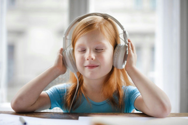 Child listening to headphones