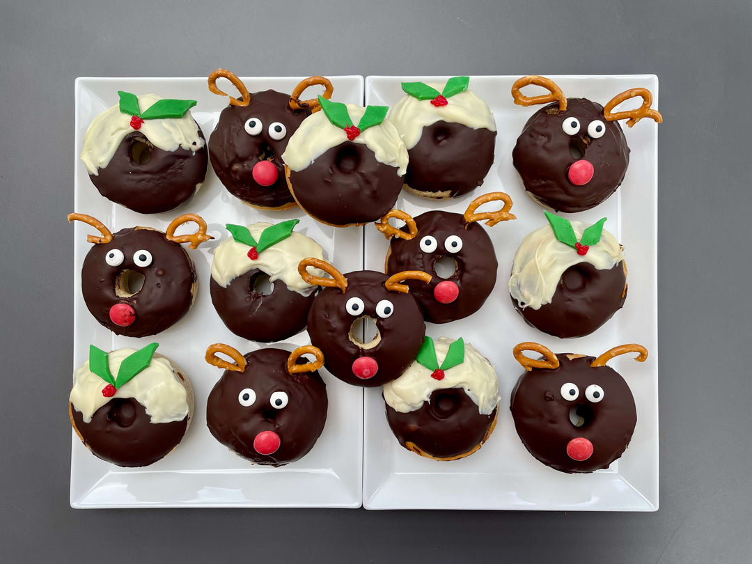 Tray of Christmas doughnuts resembling Christmas Puddings and reindeer