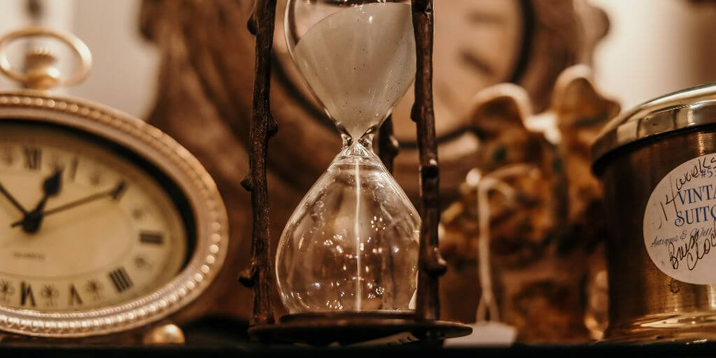 Sepia imagine of clocks and hour glass