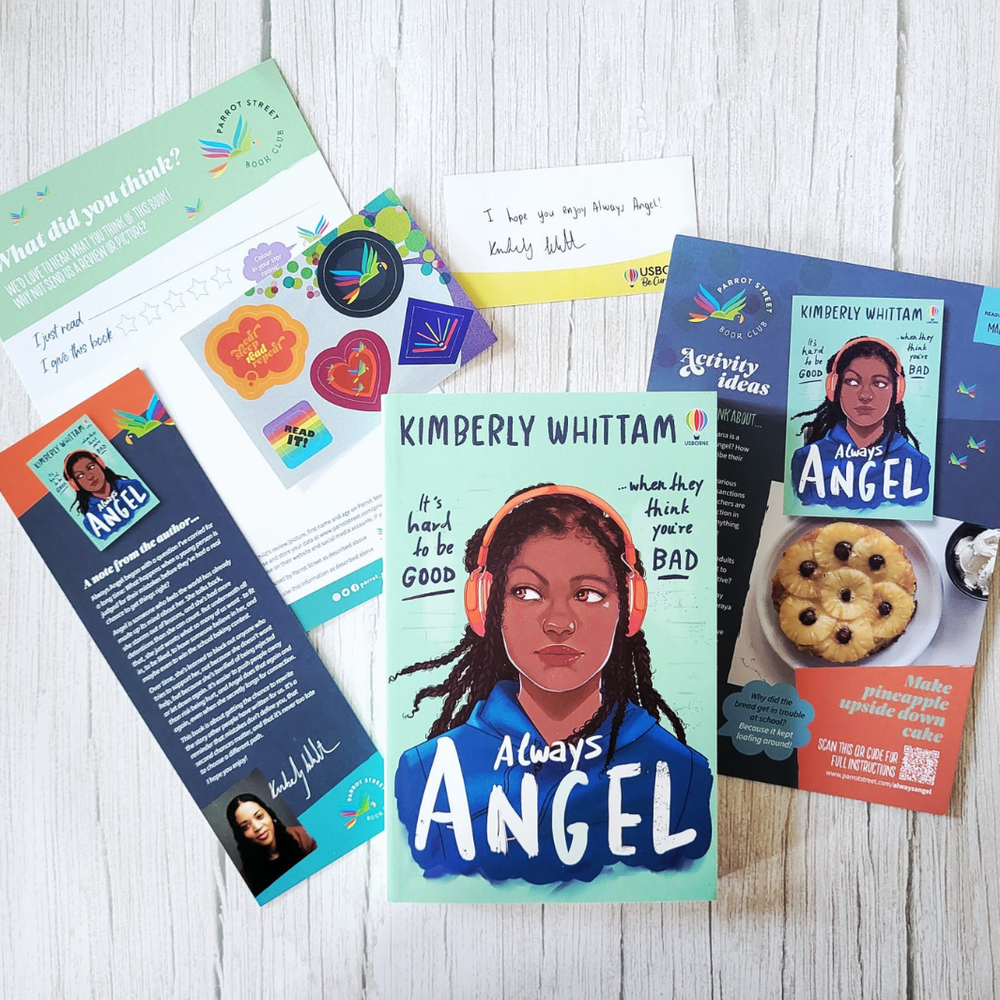 Collection of 'Always Angel' books and materials on a wooden surface