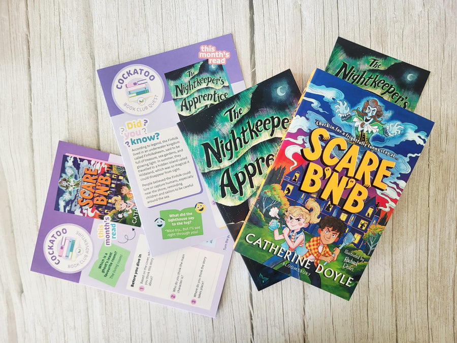 Collection of children's books and brochures on a wooden surface