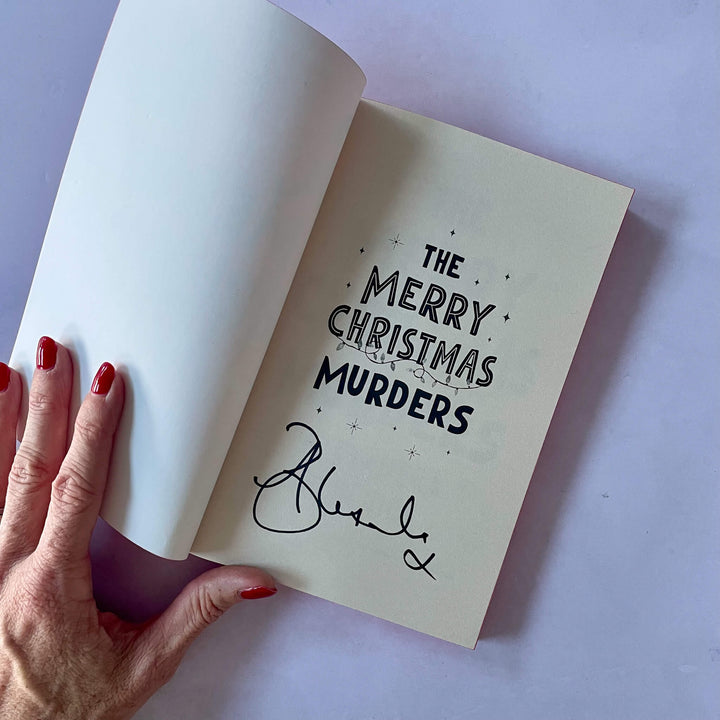 Open page of The Merry Christmas Murders showing it signed by the author Alexandra Benedict