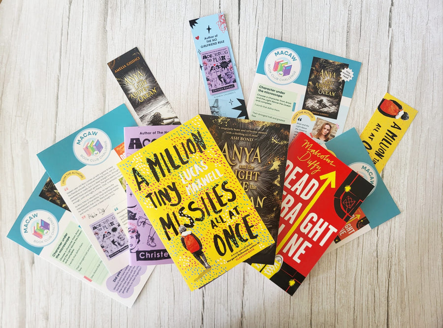 Collection of book covers and bookmarks on a wooden surface