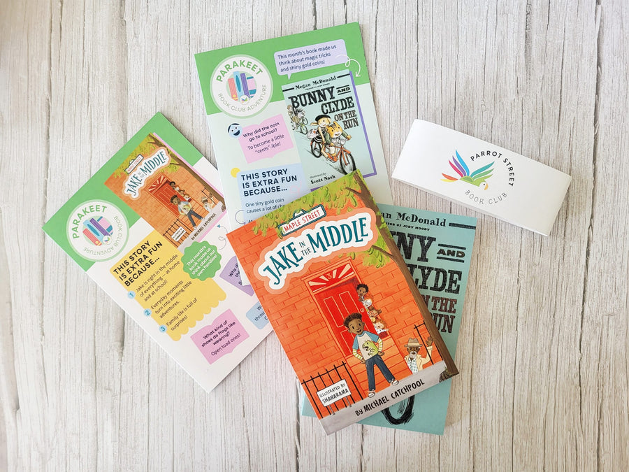 Collection of children's books and a envelope on a wooden surface