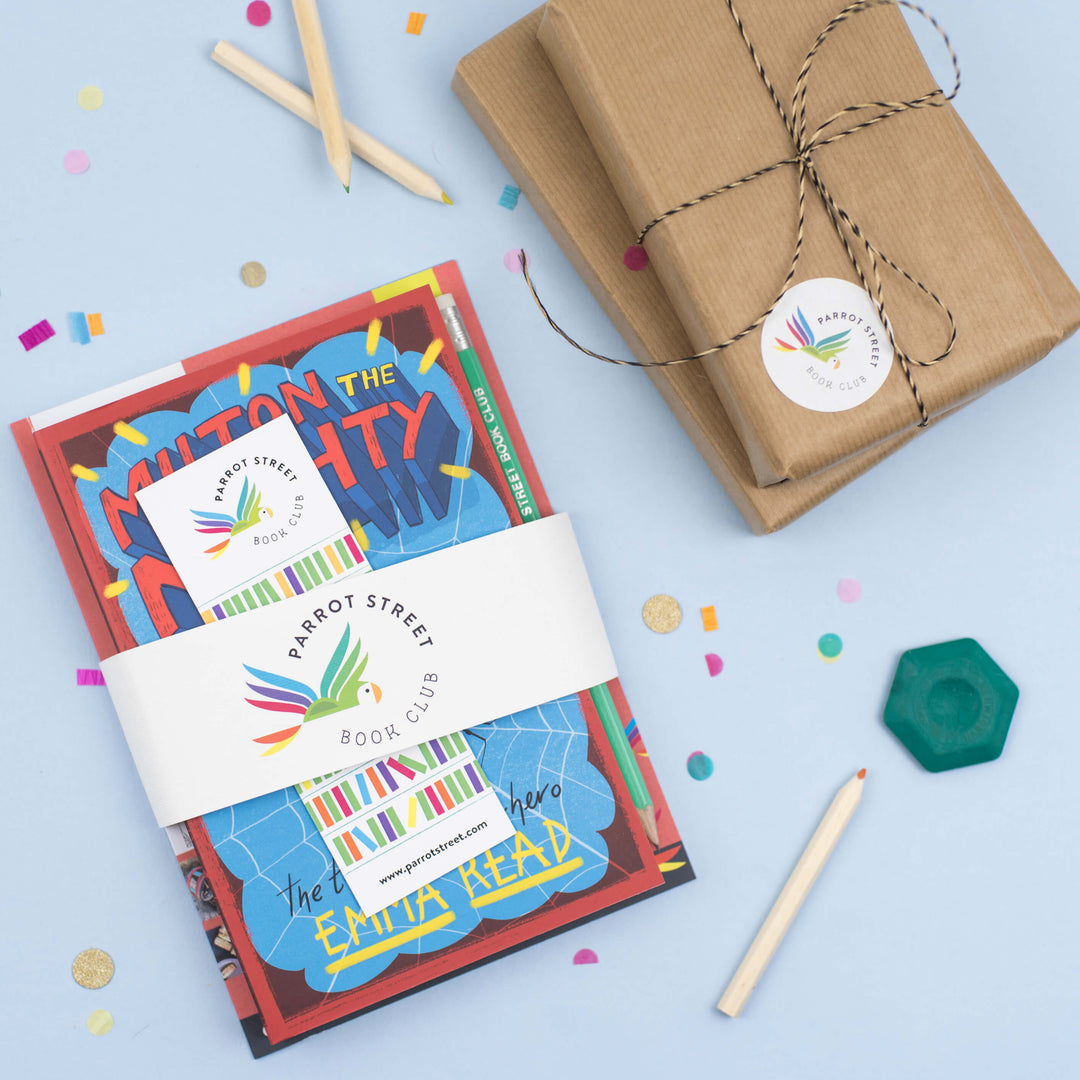 An example of a wrapped Parrot Street Book Club book and activity bundle, surrounded by confetti