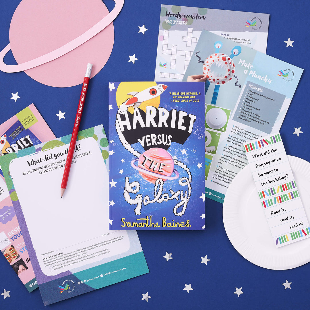 Example contents of a Parakeet book subscription box for early readers, surrounded by paper stars and planets