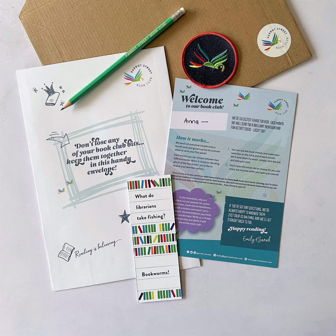 The contents of a the Macaw subscriber welcome pack including an embroidered patch, pencil, bookmark and welcome notes.