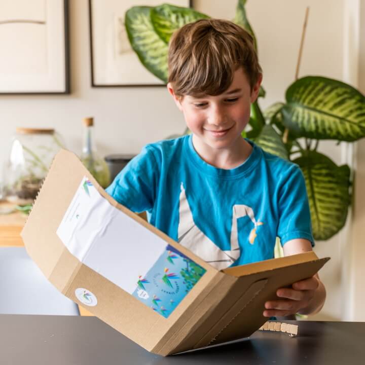 A tween opening a Parrot Street Book Club subscription box