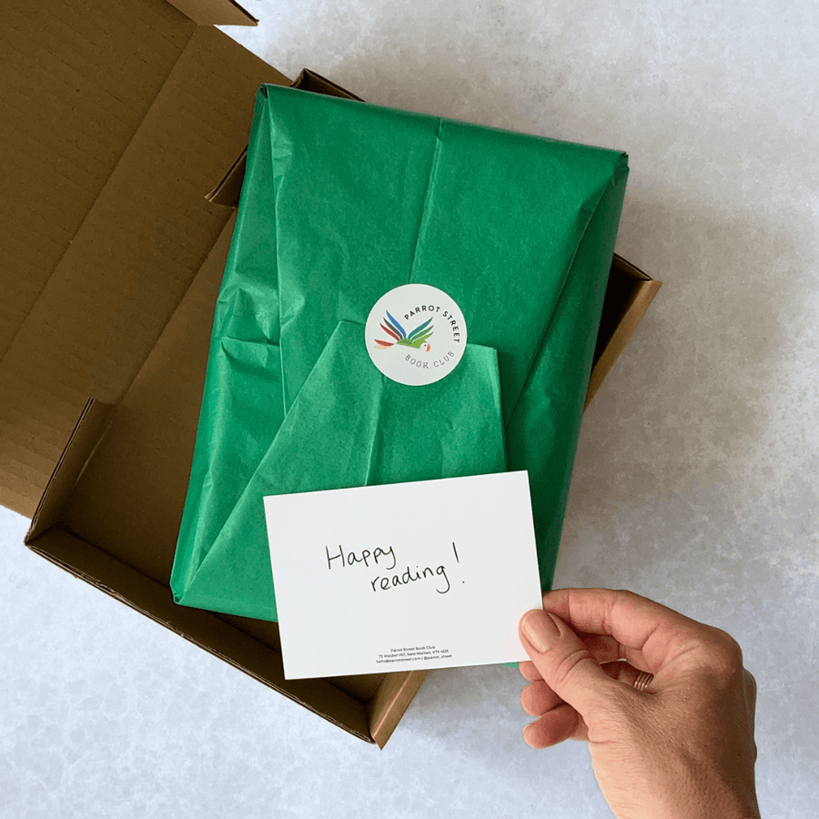 A tissue-wrapped parcel with a Parrot Street Book Club sticker and handwritten notecard