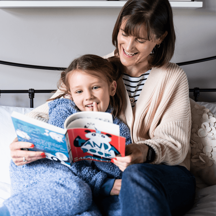 Sarah Campbell, co-founder of Parrot Street Book Club reading a book with a young child