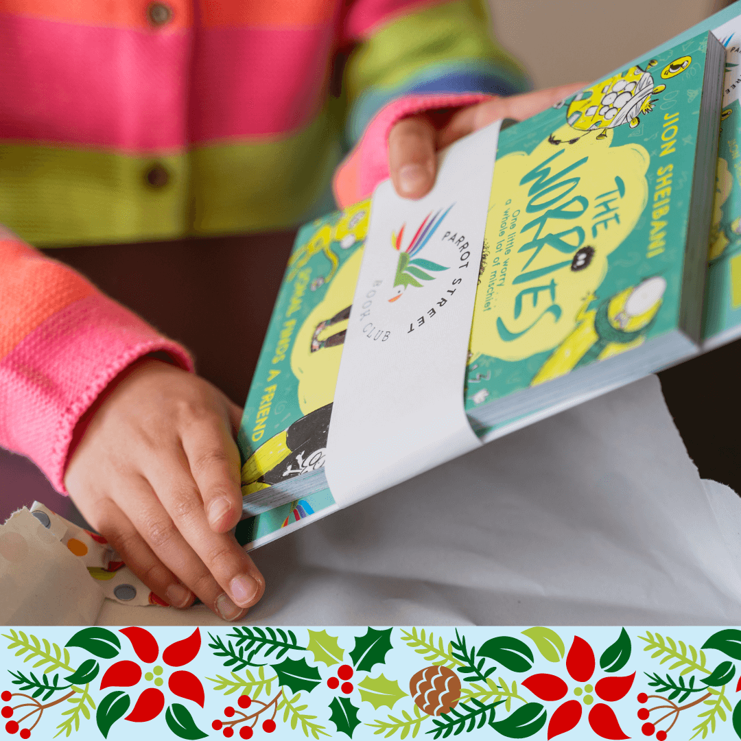 Close up of a child's hands as they unwrap a chapter book and activity pack bundle